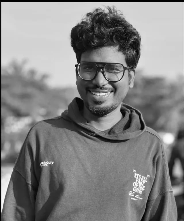 Black and white portrait of Akhil, smiling, in a hoodie