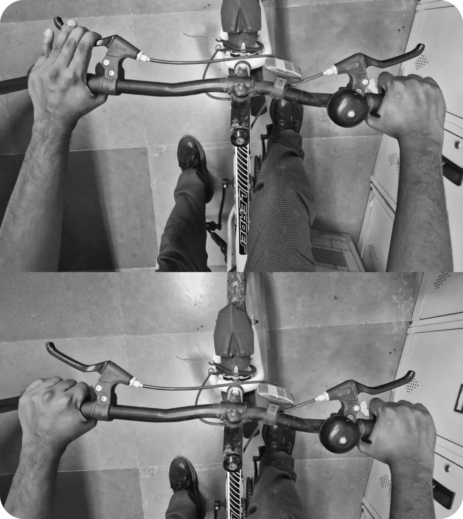 Top-down views of two hands on a bicycle handlebar rigged with sensors in class